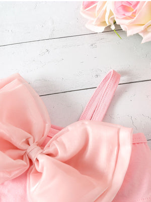 Pink bikini top with large satin bowknot detail and spaghetti strap.