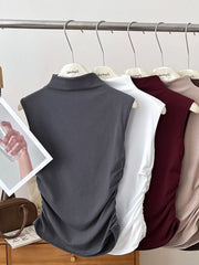Dark gray ruched mock neck tank top with draped side detail.