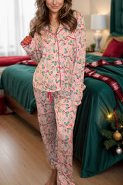 Blush pink pajama set with holly print, red piping, and button front.