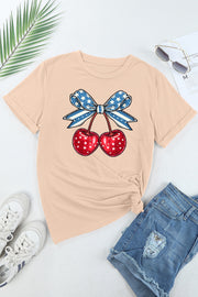 Tan graphic t-shirt with patriotic cherries and bow design.