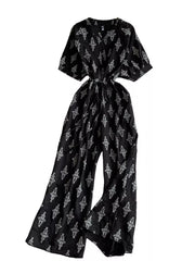 Black patterned jumpsuit with drawstring waist and wide legs.