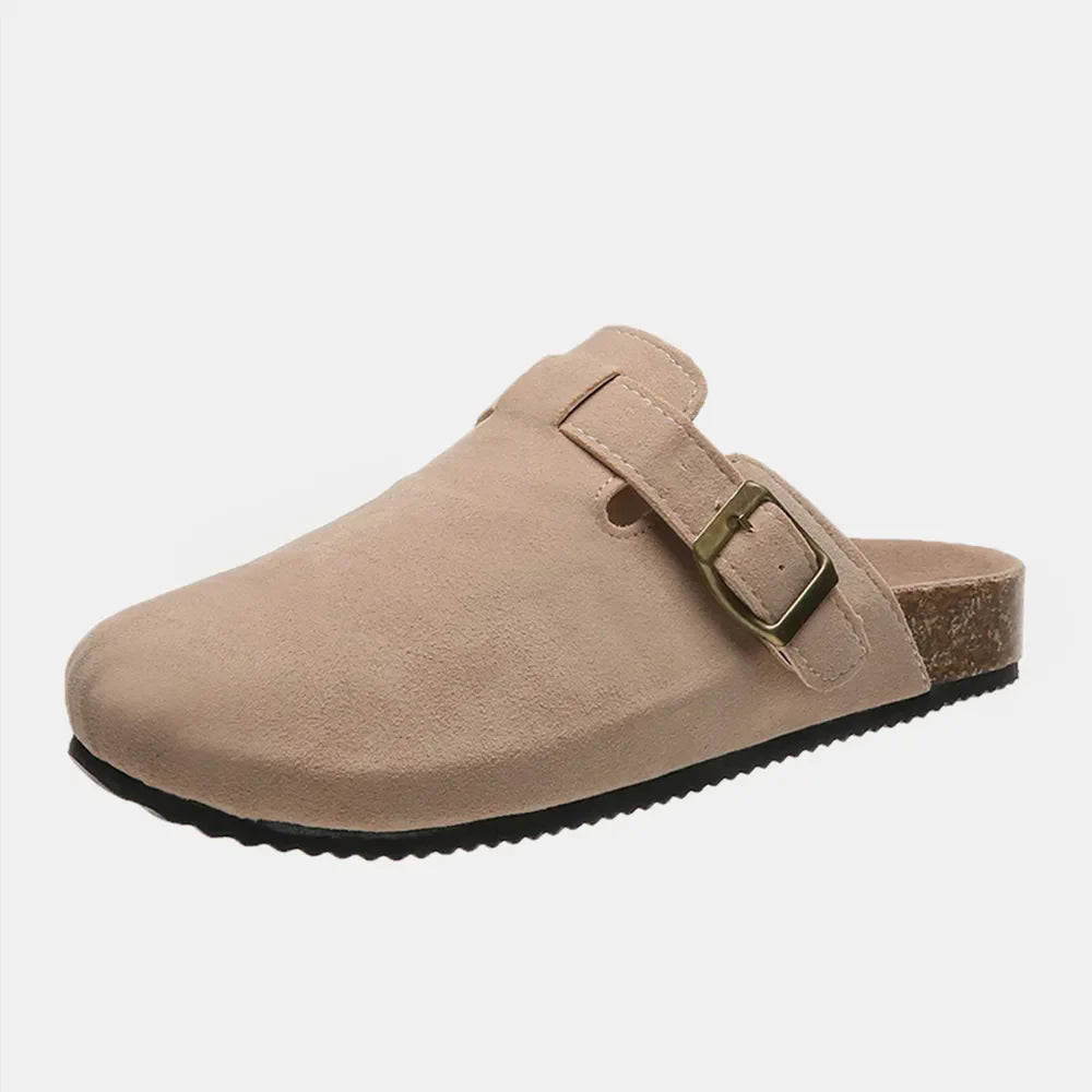 Beige suede clog slides with adjustable buckle and cork sole.