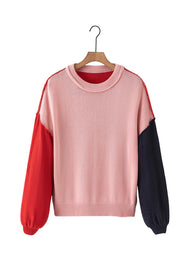 Chic contrast sweater with pink body, red and navy balloon sleeves, and crewneck.