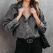 Dark gray acid-washed denim button-up shirt with puffed sleeves and button cuffs.