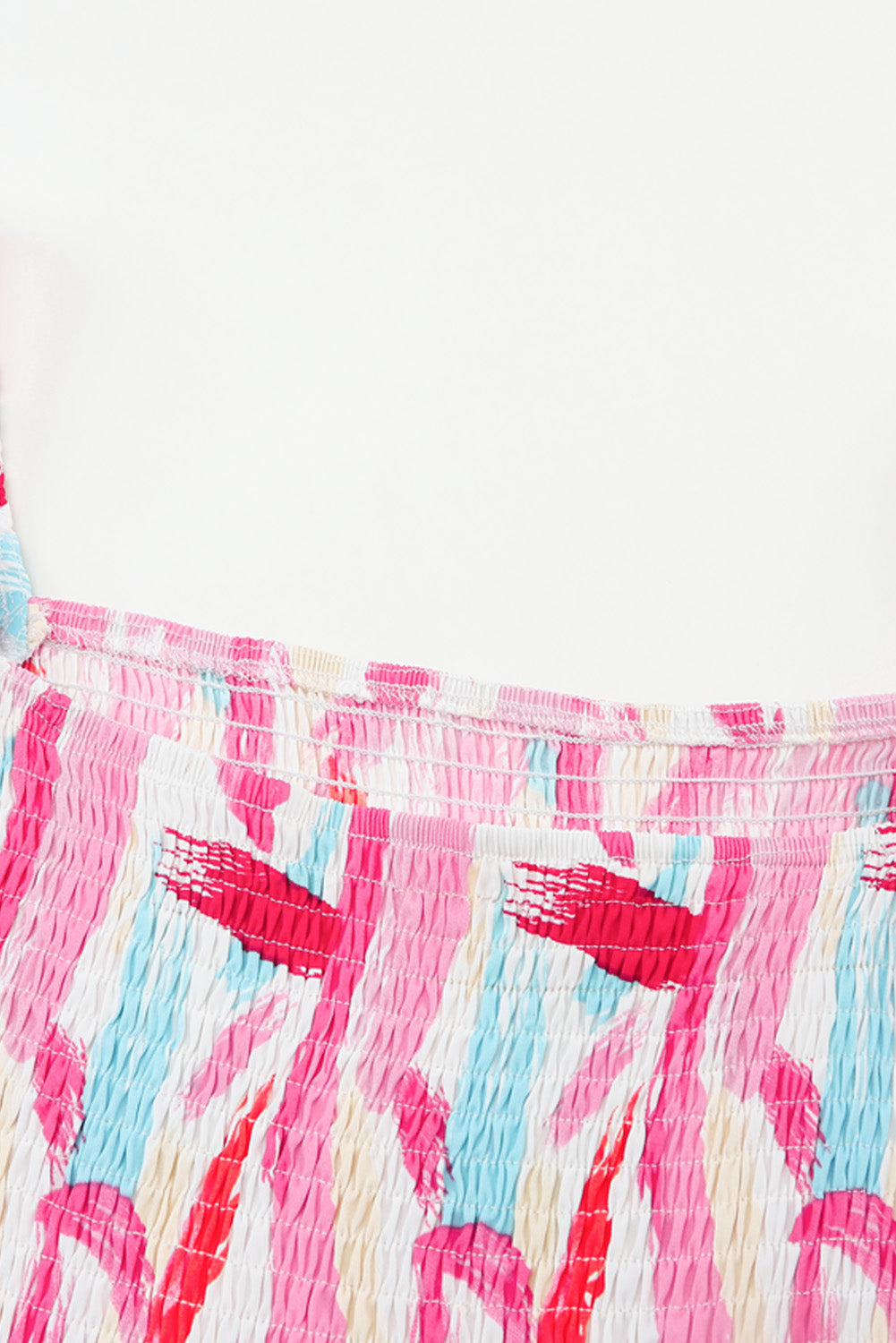 Smocked bodice midi dress in blush pink with abstract brushstroke print and balloon sleeves.