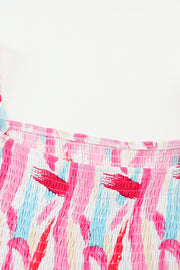 Smocked bodice midi dress in blush pink with abstract brushstroke print and balloon sleeves.