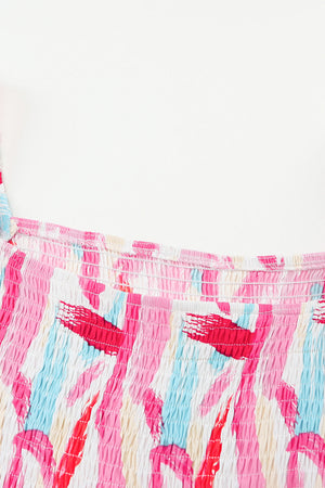 Smocked bodice midi dress in blush pink with abstract brushstroke print and balloon sleeves.