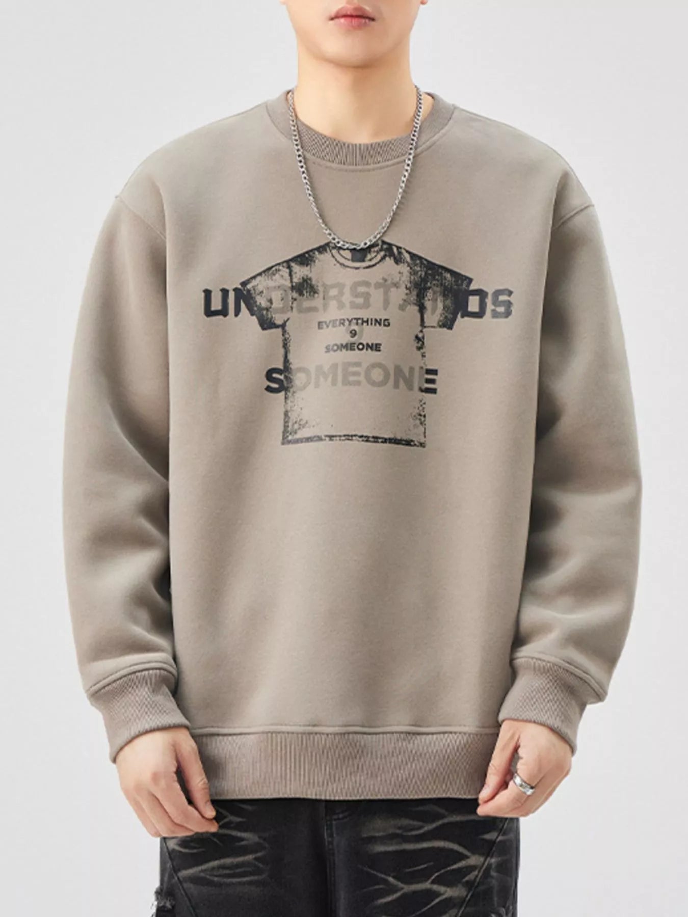 Men's oversized khaki graphic sweatshirt with crewneck and distressed print.