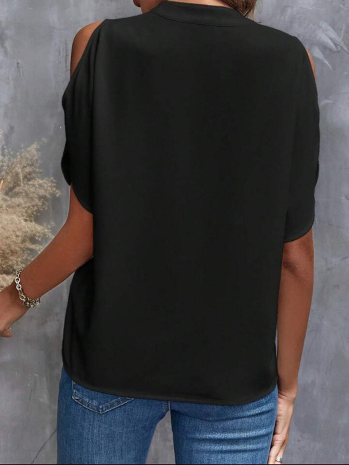 Black open-shoulder blouse with mandarin collar and short sleeves.
