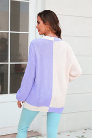 Colorblock knit cardigan in lavender and cream acrylic with contrast trim.