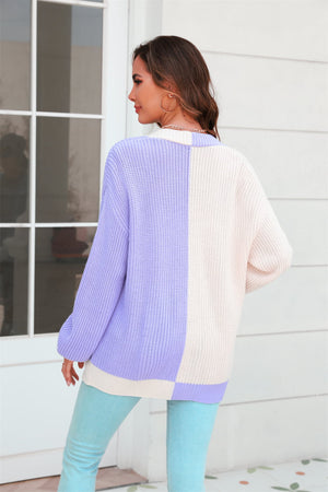 Colorblock knit cardigan in lavender and cream acrylic with contrast trim.