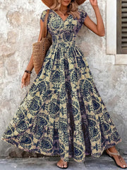 Maxi dress with smocked bodice, v-neck, short sleeves, and tiered skirt in a dark blue floral pattern.