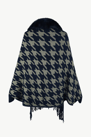 Houndstooth poncho with faux fur collar and fringe trim in dark blue and beige.