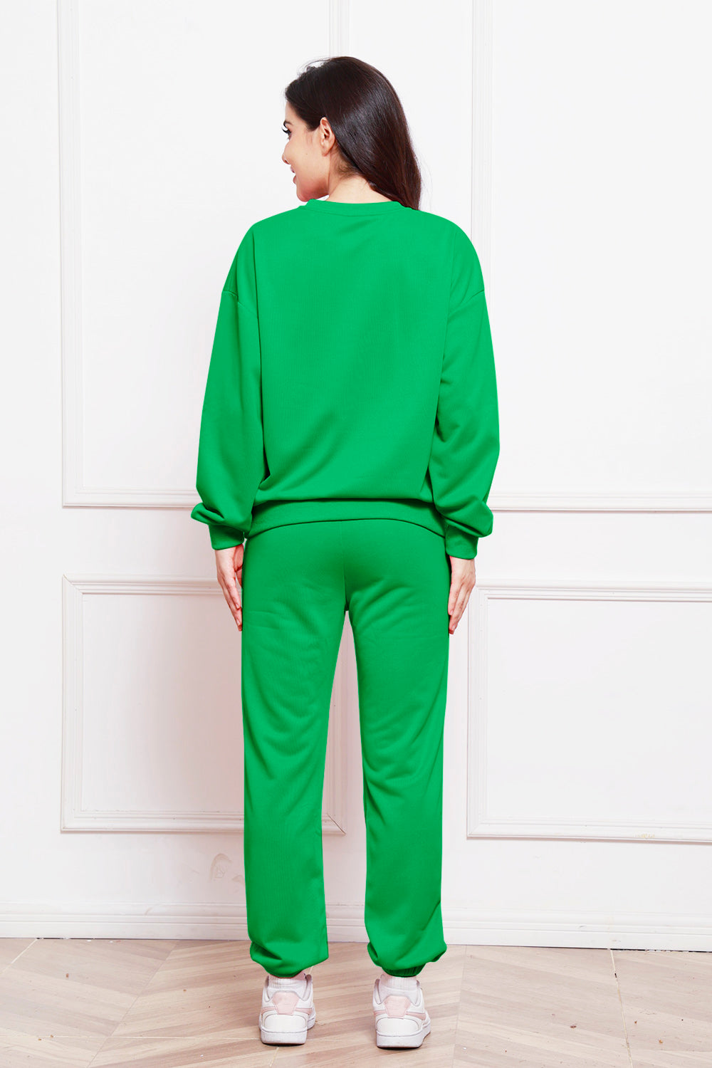 Green relaxed fit loungewear set with crewneck sweatshirt and sweatpants.
