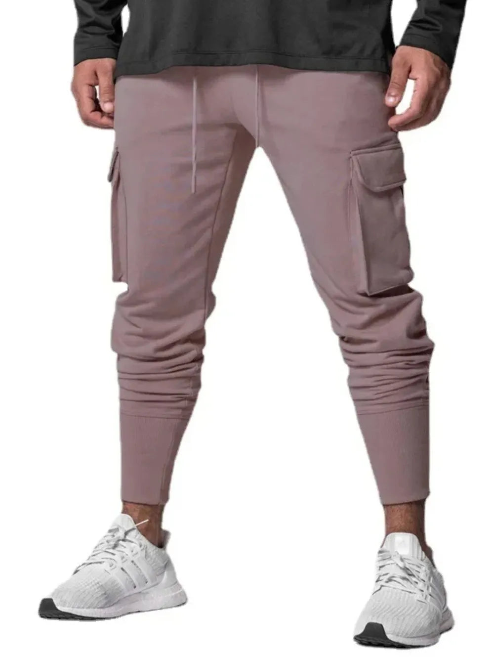 Dusty pink Tech-Knit cargo joggers with drawstring waist and zip pocket detail.
