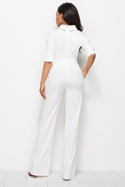 White high-neck belted palazzo jumpsuit with half sleeves and wide legs.