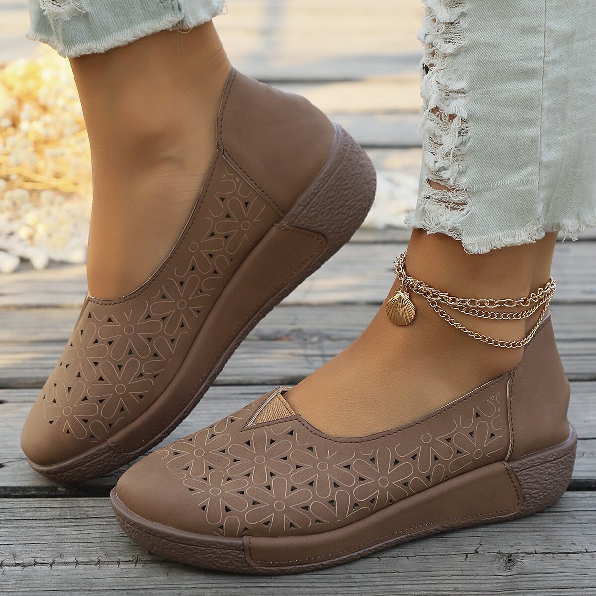 Brown floral cutout slip-on loafers with a seashell anklet.