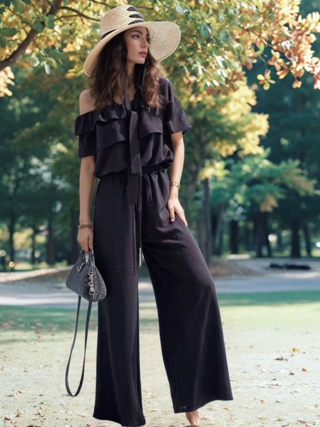 Black off-shoulder ruffle palazzo jumpsuit with tie waist and wide legs.