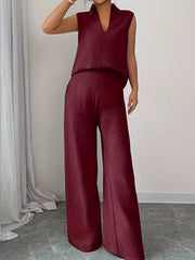 Burgundy sleeveless collared top and wide-leg pants set with textured fabric.