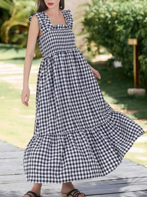 Black gingham midi dress with ruffled square neck and sleeves, smocked bodice, tiered skirt.