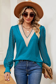 Turquoise v-neck knit top with lace sleeves and V-neck trim.