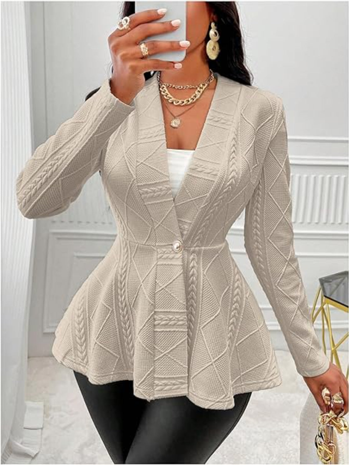 Tan textured knit peplum blazer with a single button closure and shawl collar.