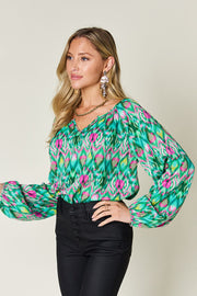 Green prismatic ikat blouse with voluminous sleeves and V-neck