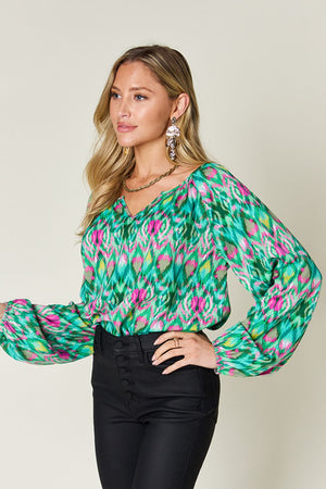 Green prismatic ikat blouse with voluminous sleeves and V-neck