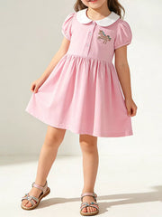 Pink cotton toddler dress with unicorn embroidery and white collar.
