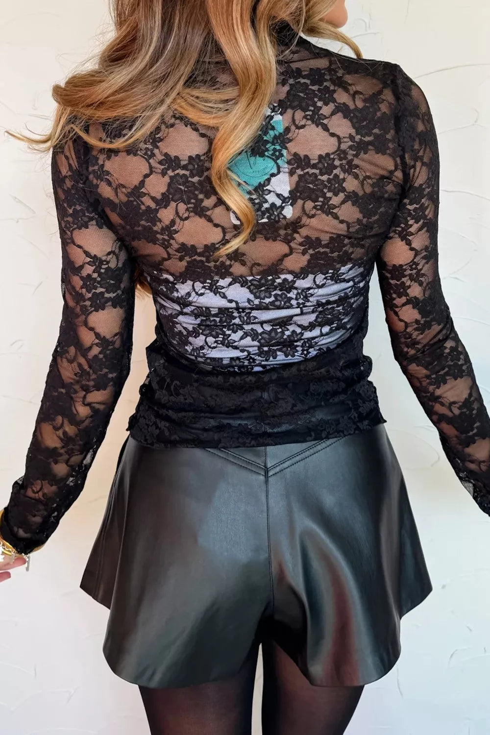 Black sheer floral lace long sleeve fitted shirt with ruched detail.