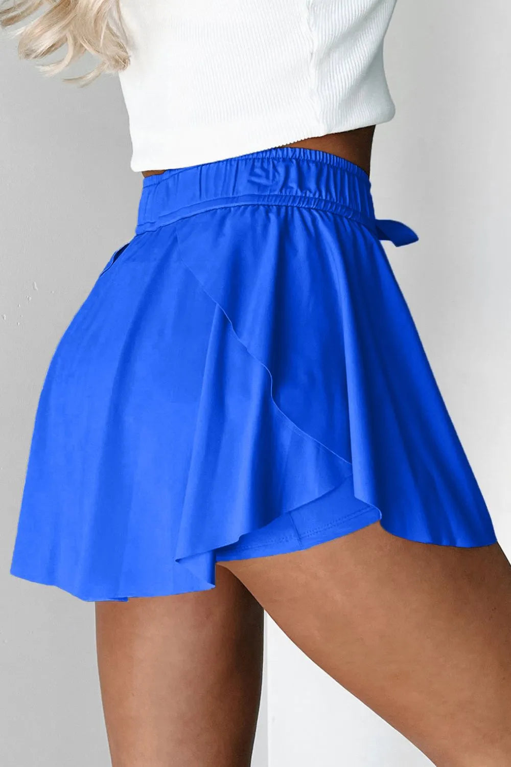 Blue flared skort with tie waist and elastic waistband.