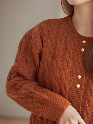 Caramel cable knit cardigan with puff sleeves and gold buttons.