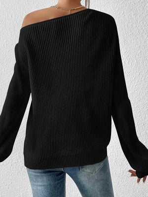 Black asymmetrical knit sweater with off-shoulder neckline and long sleeves.