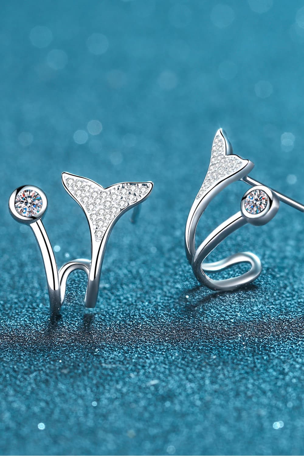 Silver stud earrings with crystal accents in a whimsical whale tail design