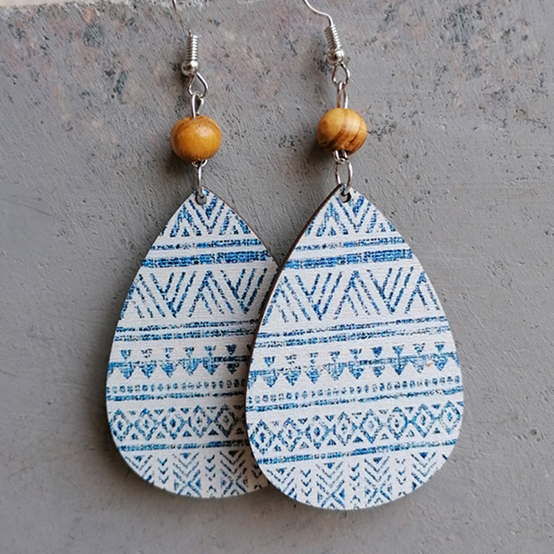 Botanical drop earrings with wood bead and blue tribal pattern
