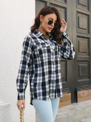 Black plaid overshirt with flap pockets and buttoned front, styled casually.
