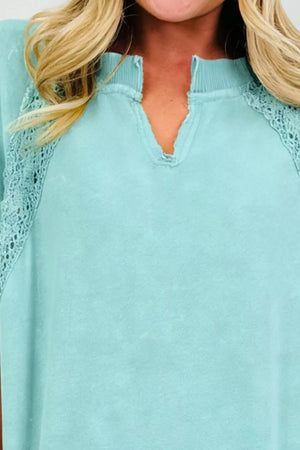 Distressed notched V-neck cotton tee with lace shoulder details.