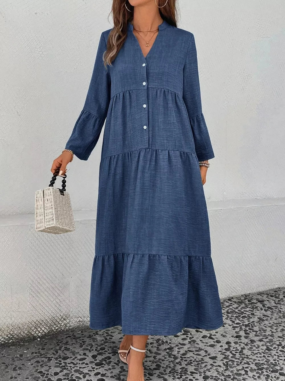 Blue tiered ruffle hem v-neck dress with button front and bell sleeves.