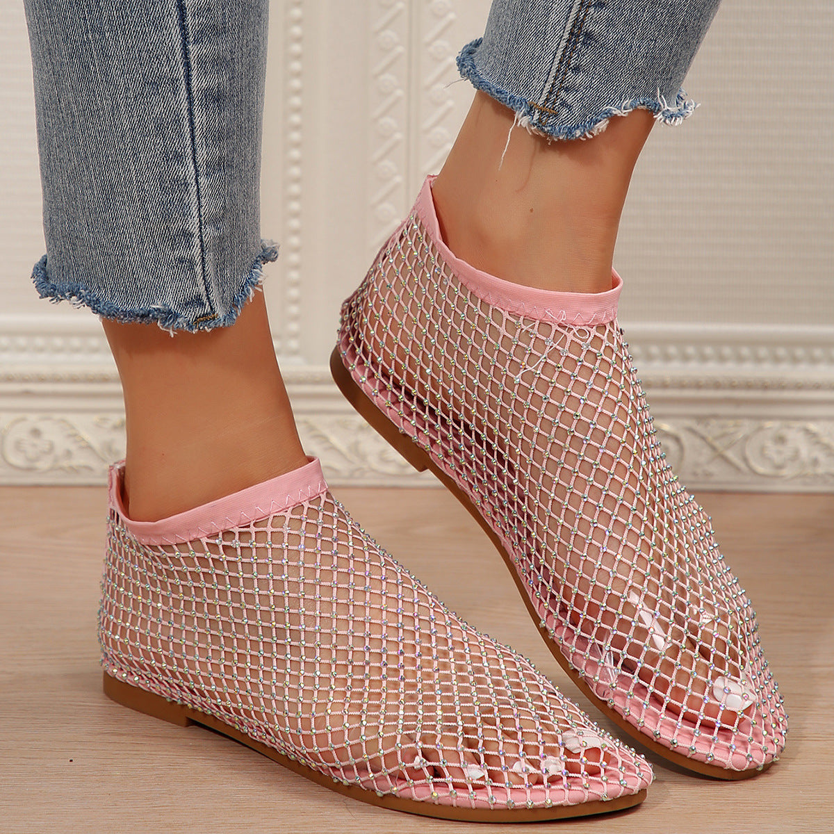 Pink mesh ankle boots with rhinestones and a round toe.