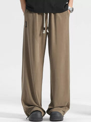 Men's light brown loose fit sweatpants with drawstring waist and cuffed ankles.
