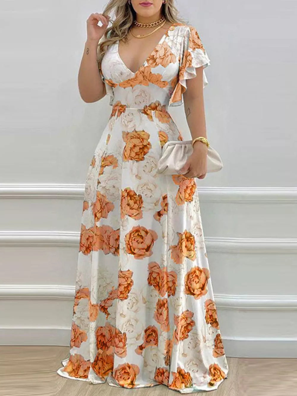 Maxi dress with floral print, V-neck, and ruffle sleeves in pumpkin orange.