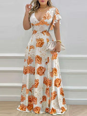Maxi dress with floral print, V-neck, and ruffle sleeves in pumpkin orange.