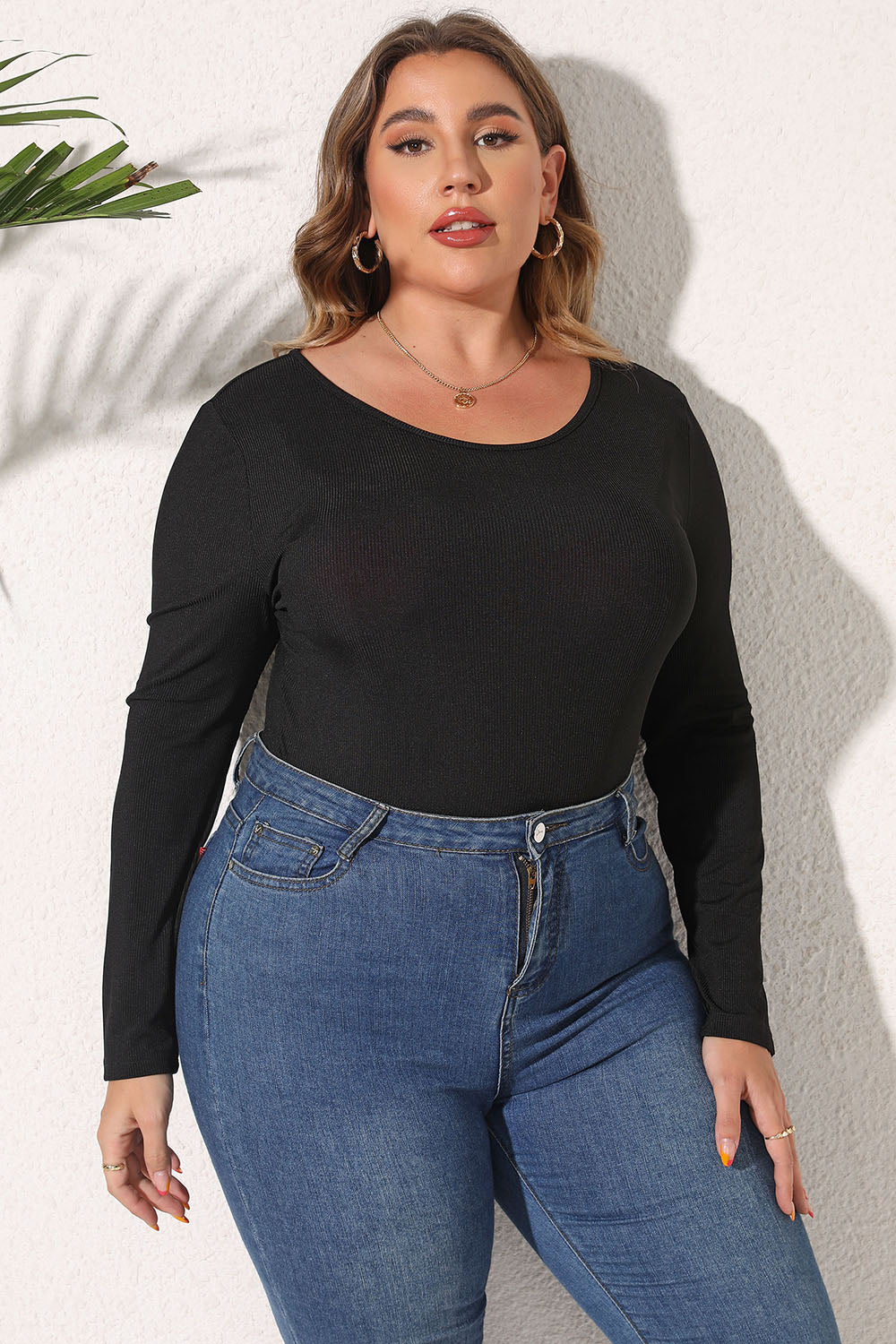 Black ribbed scoop neck long sleeve bodysuit styled with blue jeans.