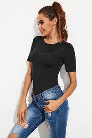 Black crew-neck jersey bodysuit with short sleeves, styled with ripped jeans.