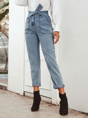 Light wash denim paperbag waist tapered trousers with tie belt and cuffed hems.