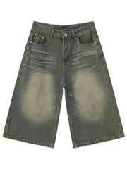 Wide-leg denim culotte shorts in a distressed dark gray wash with a buttoned fly and classic five-pocket styling.