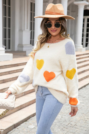 Ivory fluffy knit sweater with multicolor heart pattern, crew neck, long sleeves.
