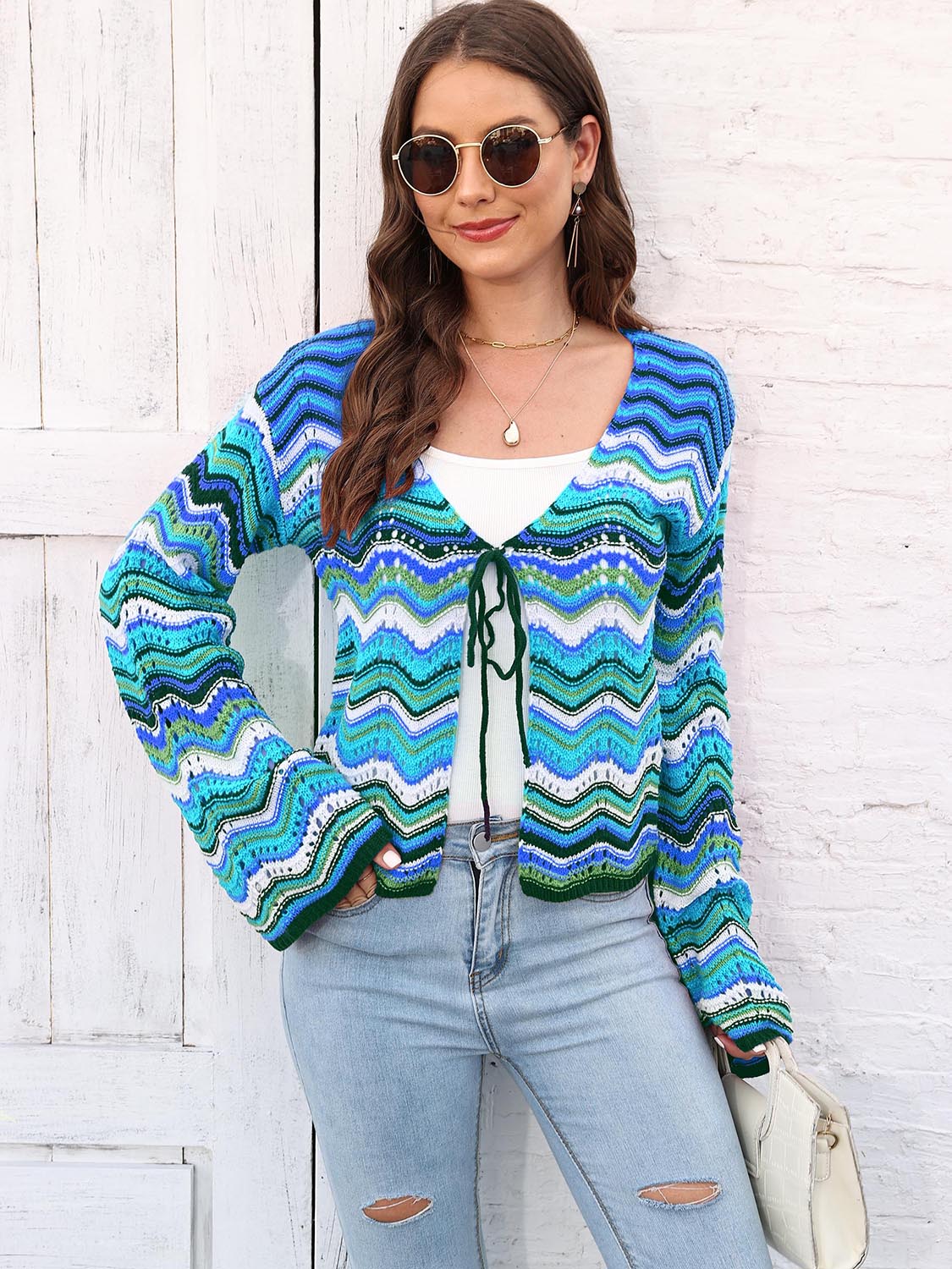 Chevron knit tie-front cardigan in blue and green with white accents, featuring a V-neck and long sleeves.