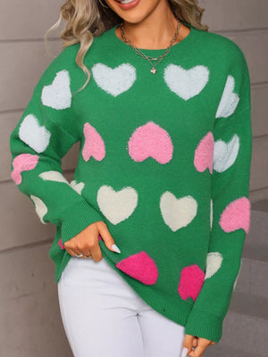 Green fuzzy knit sweater with scattered pink and white hearts, crew neck, long sleeves.