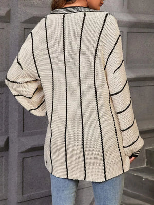 Textured knit sweater with vertical black stripes and V-neck.